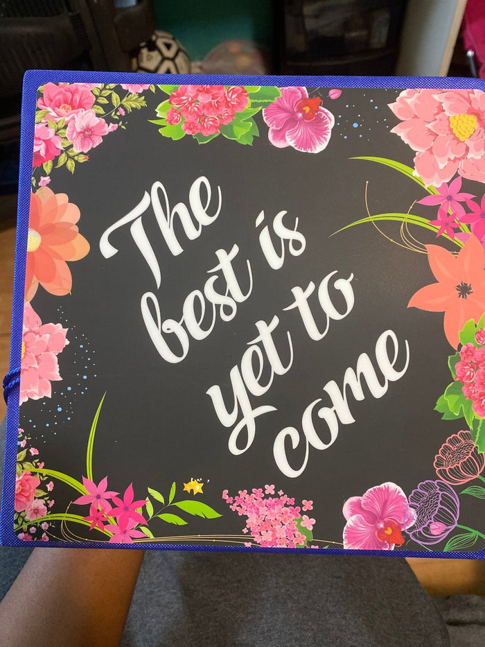 The Best Is Yet To Come floral cap on graduates lap