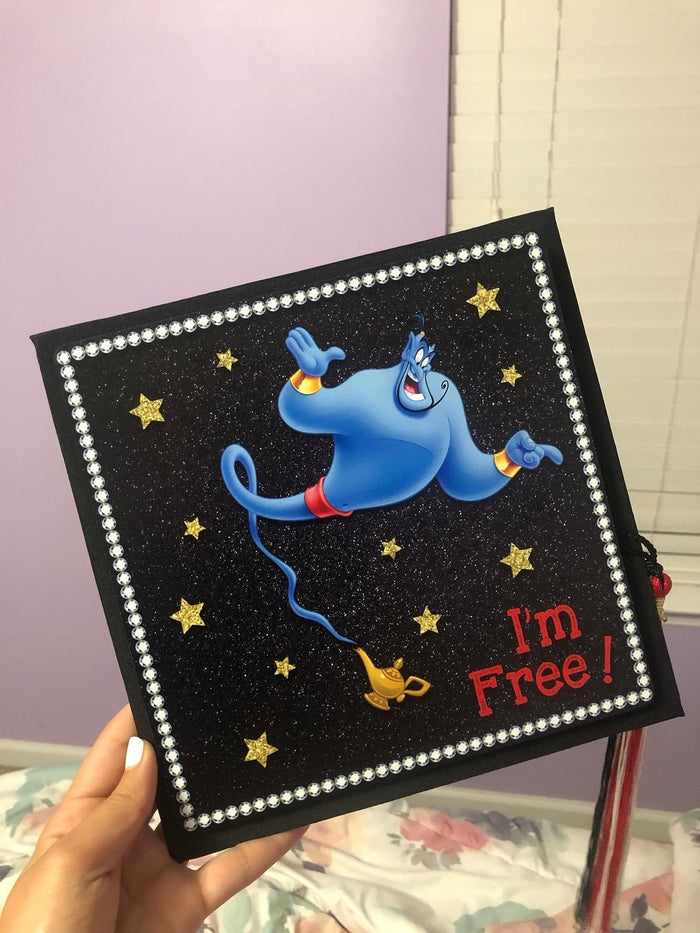 Hand holding Aladdin Genie Im Free topper