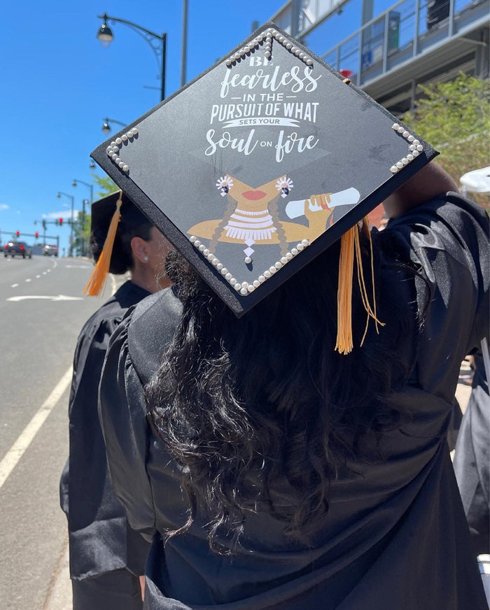Graduates wearing Be Fearless caps on street