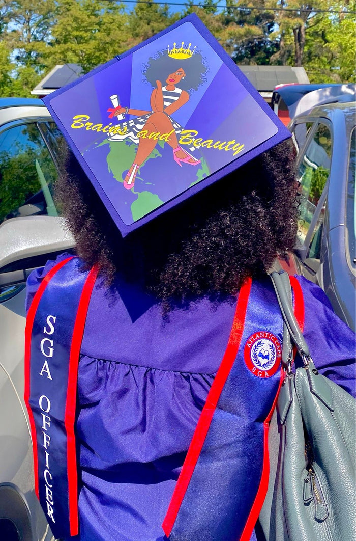Graduate wearing Brains And Beauty cap outdoors