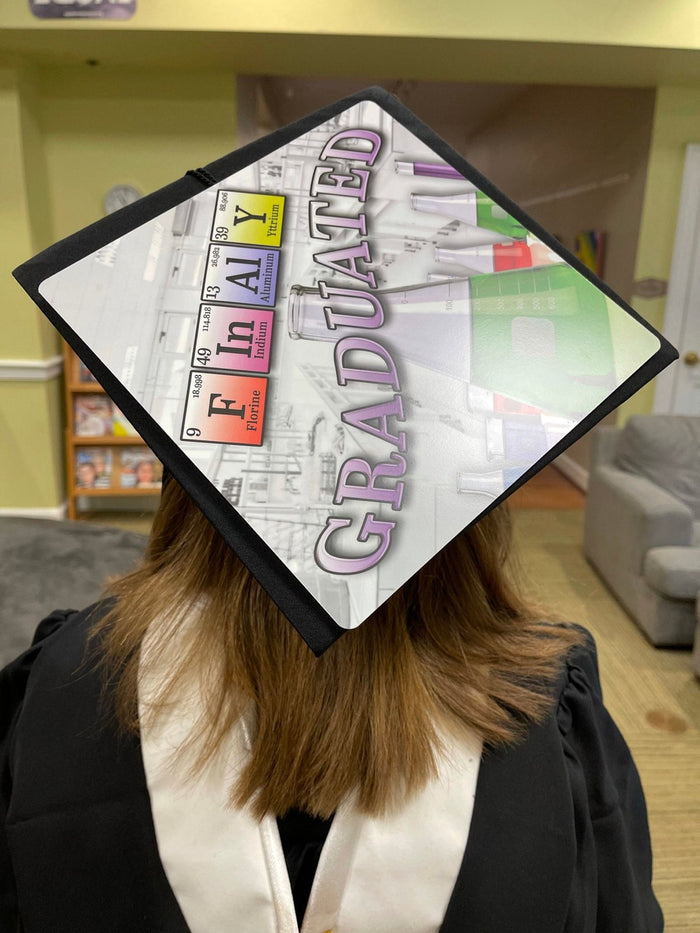 Graduate wearing Finally Graduated periodic table cap