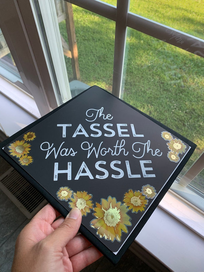 Hand holding Tassel Was Worth The Hassle topper