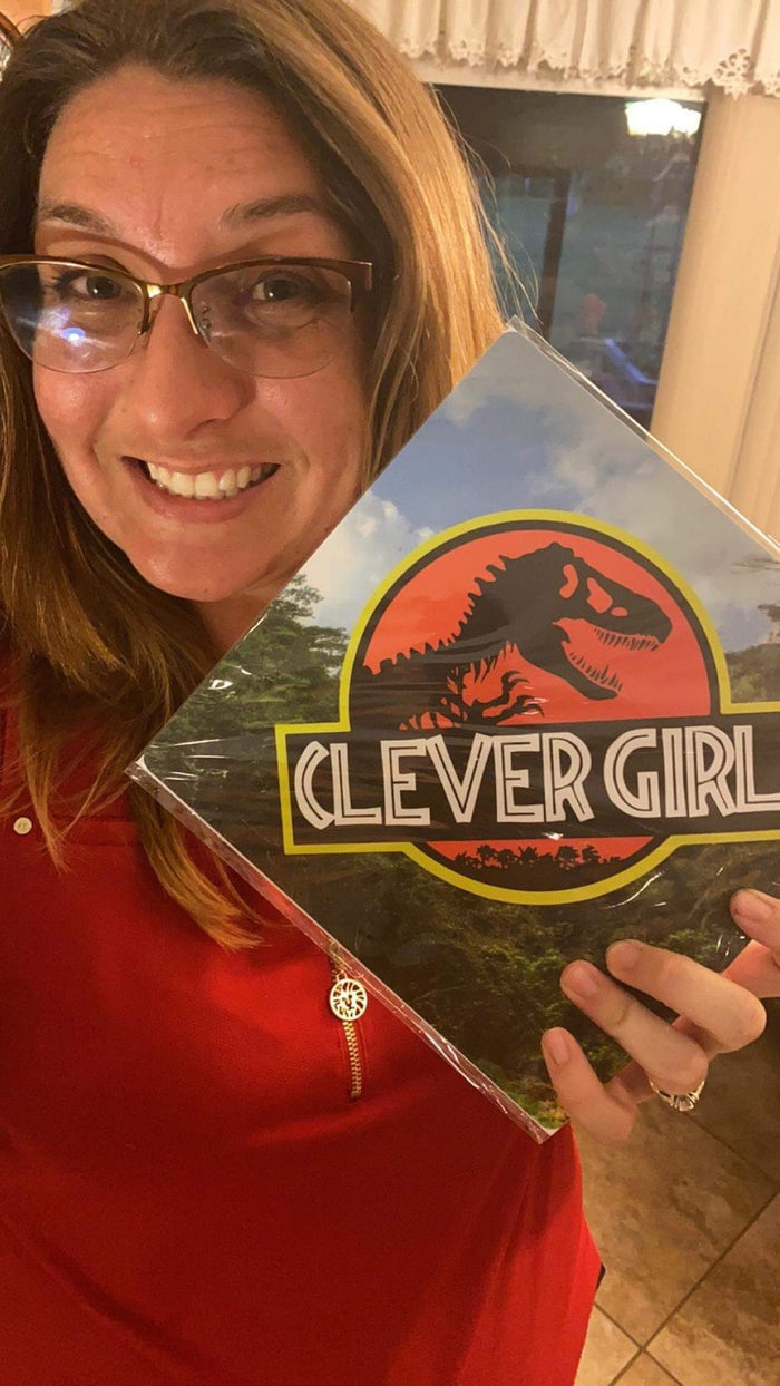 Woman holding Jurassic Park Clever Girl topper