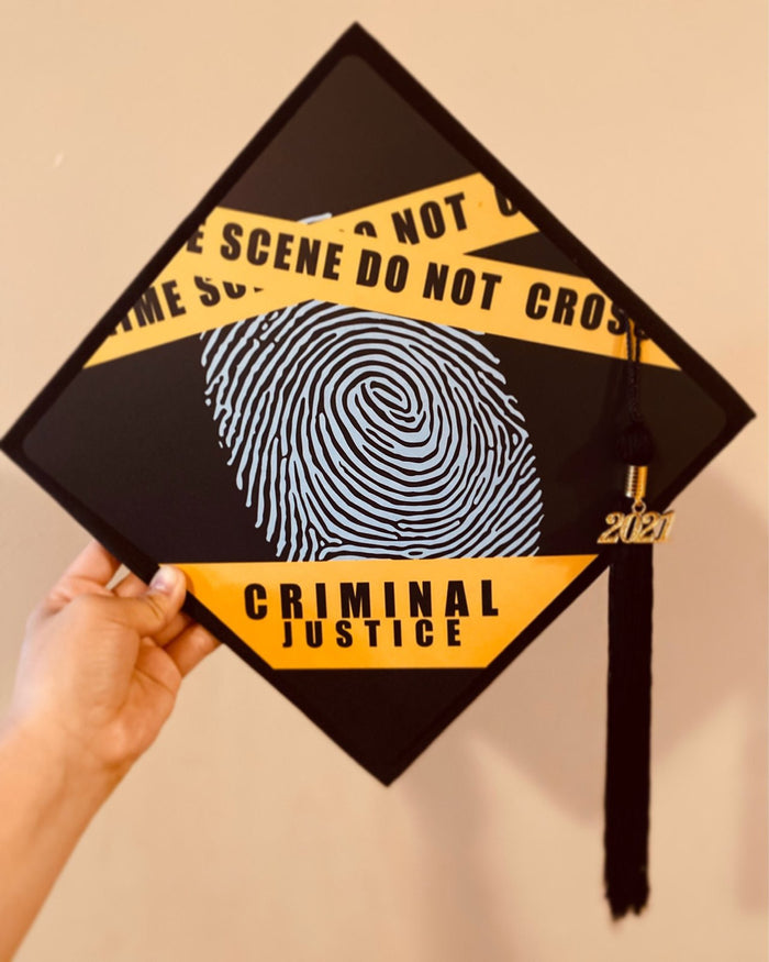 Hand holding criminal justice fingerprint topper