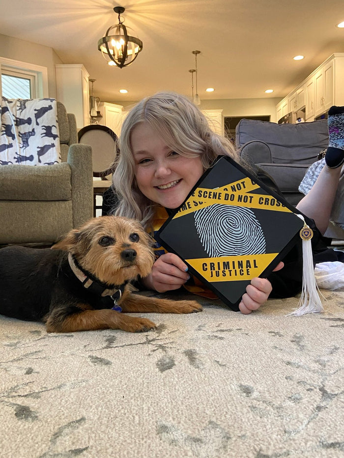 Woman with dog holding criminal justice topper