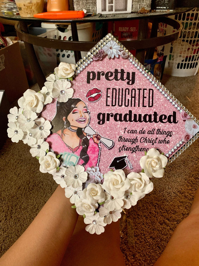 Pretty Educated Graduated floral cap on graduates lap