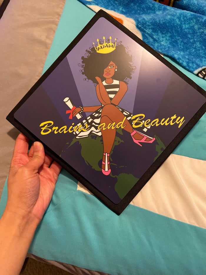Hand holding Brains And Beauty topper