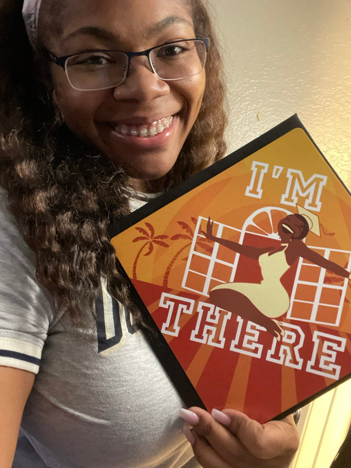 Woman holding Im There Tiana topper selfie