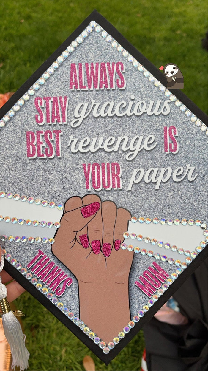 Hand holding Always Stay Gracious rhinestone cap outdoors