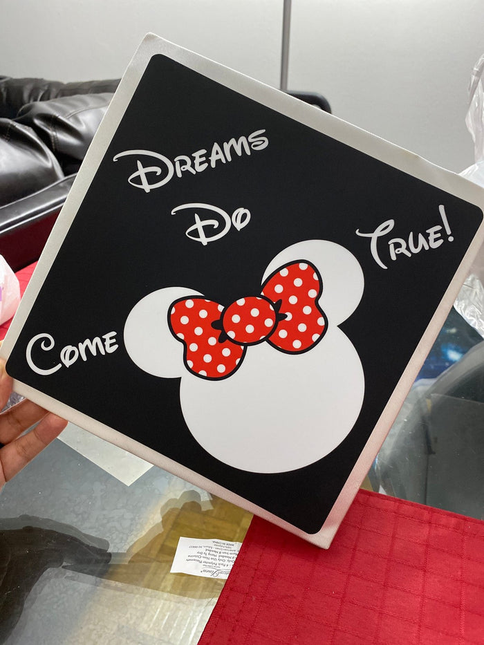 Hand holding Minnie Dreams Do Come True topper