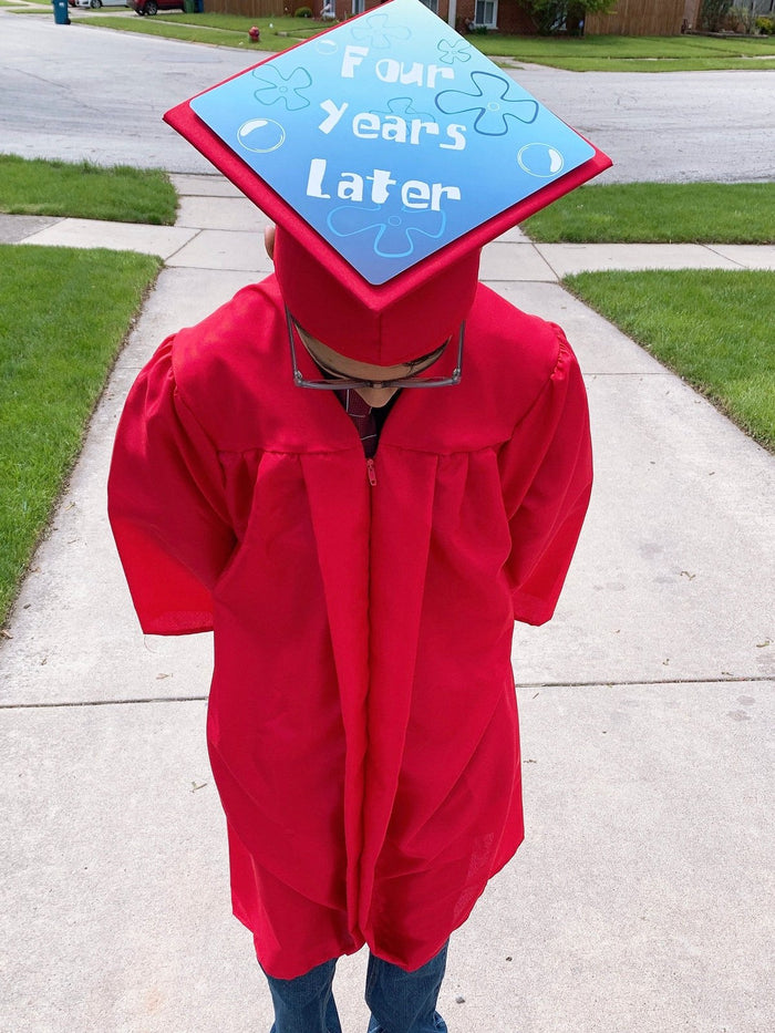 Child in red gown wearing Four Years Later cap