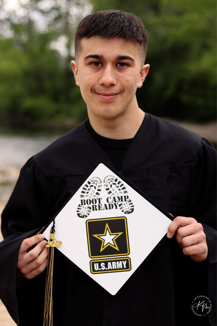Graduate holding US Army Boot Camp Ready cap