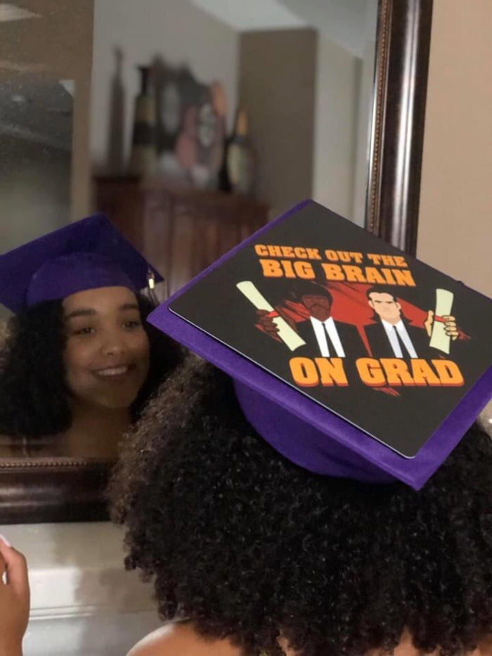 Graduates with Big Brain On Grad purple cap