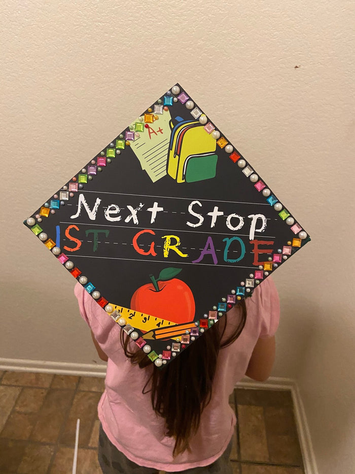 Girl wearing Next Stop 1st Grade cap
