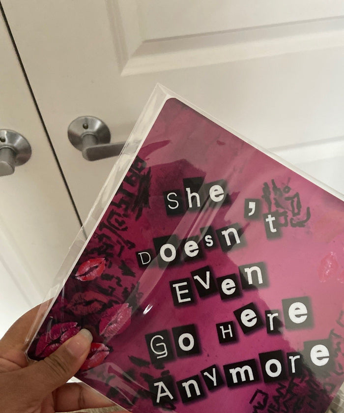 Hand holding Mean Girls topper in plastic