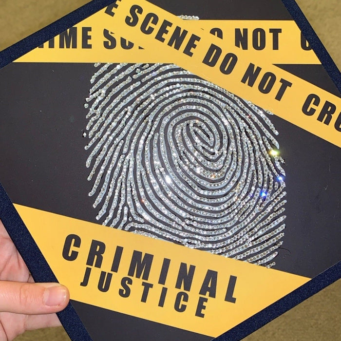 Hand holding rhinestone criminal justice topper