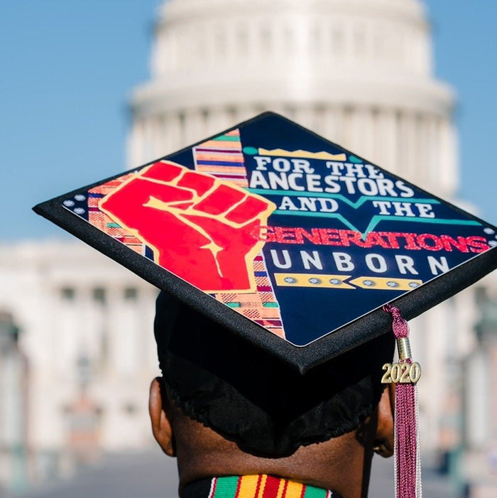 Graduate wearing BLM For The Ancestors cap at US Capitol