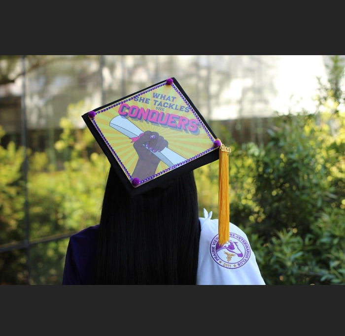 Graduate wearing What She Tackles She Conquers cap