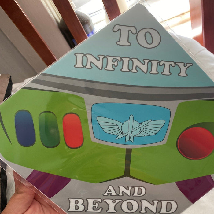 Hand holding Buzz Lightyear To Infinity topper