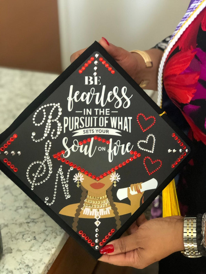Hands holding Be Fearless BSN cap