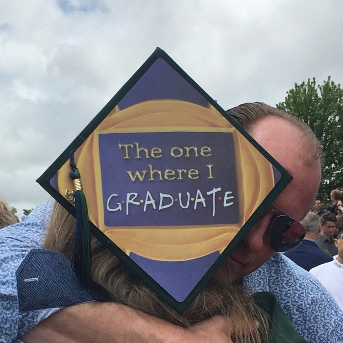 Graduate wearing Friends The One Where I Graduate cap hugging