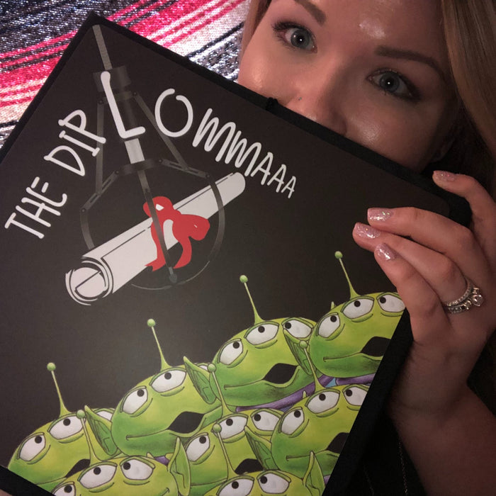 Woman holding Toy Story aliens topper by face