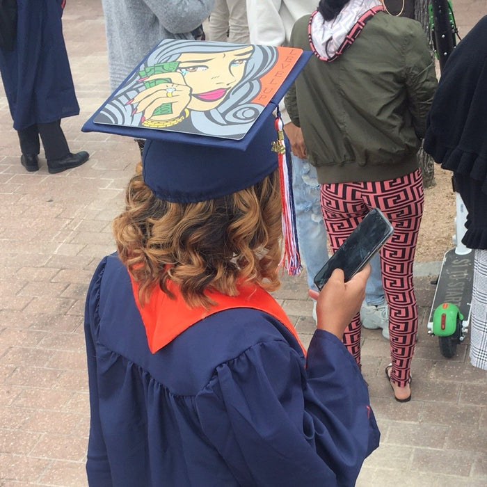 Graduate wearing pop-art money woman cap on street