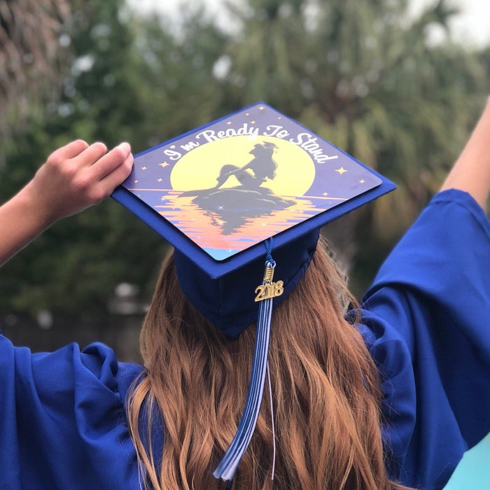 Graduate holding Ariel Im Ready To Stand cap