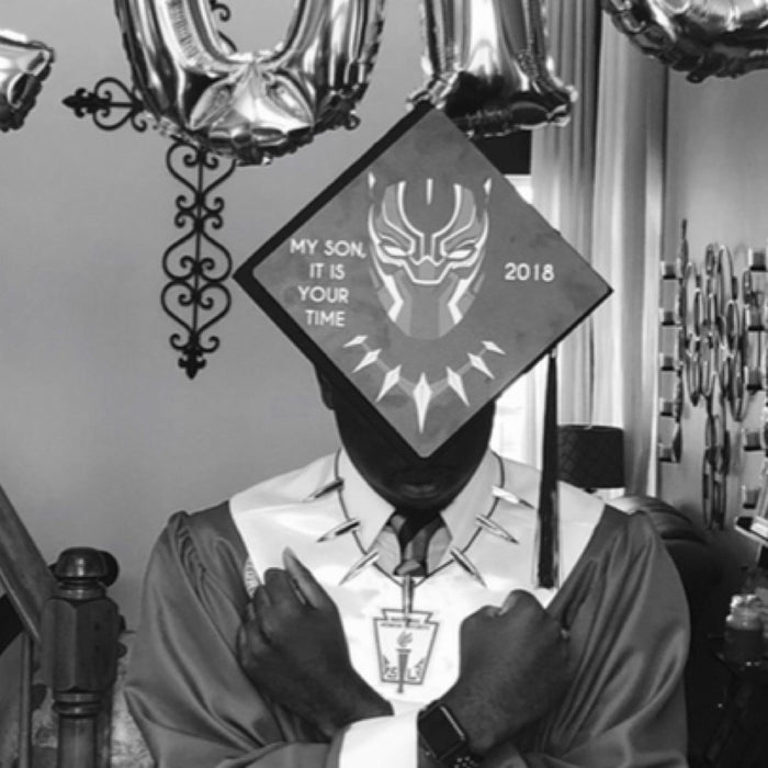 Graduate wearing Black Panther My Son It Is Your Time cap