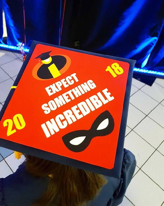 Graduate wearing Incredibles Expect Something cap