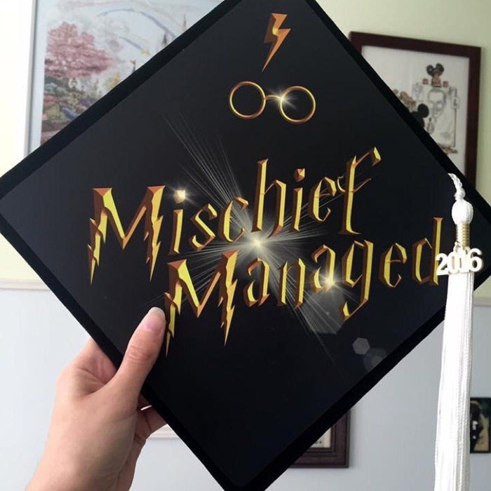 Hand holding Harry Potter Mischief Managed cap