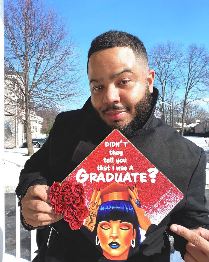 Man holding Cardi B Graduate rose cap