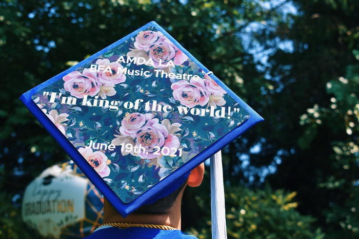 Graduate wearing Titanic King Of The World floral cap