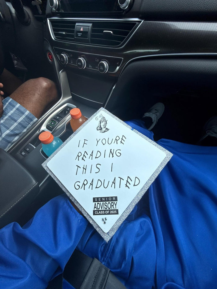 Person holding If Youre Reading This topper in car