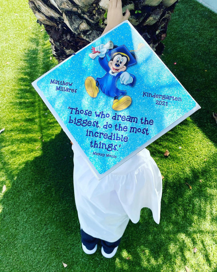 Child wearing Mickey Dream Biggest kindergarten cap