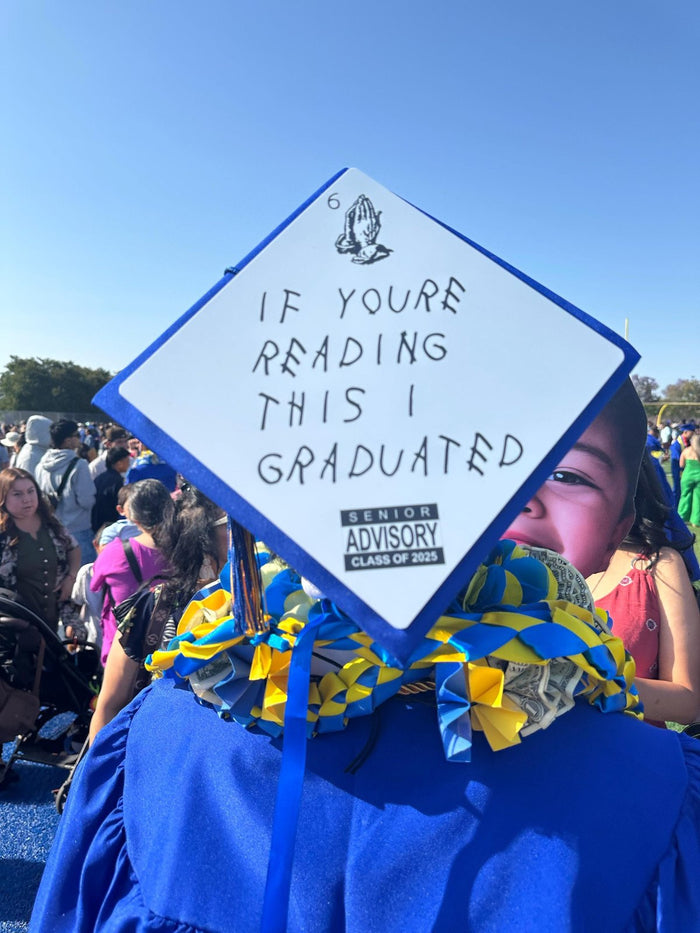 Graduate wearing If Youre Reading This cap with money lei