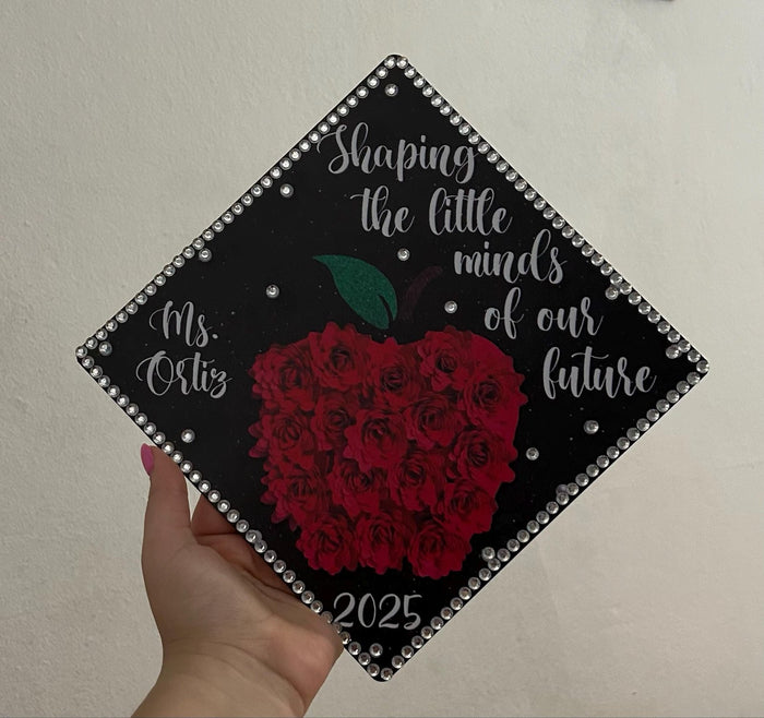 Hand holding Shaping Little Minds Ms Ortiz apple topper