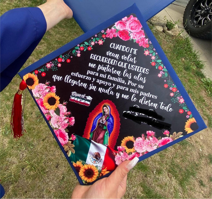 Hand holding Virgen de Guadalupe floral topper