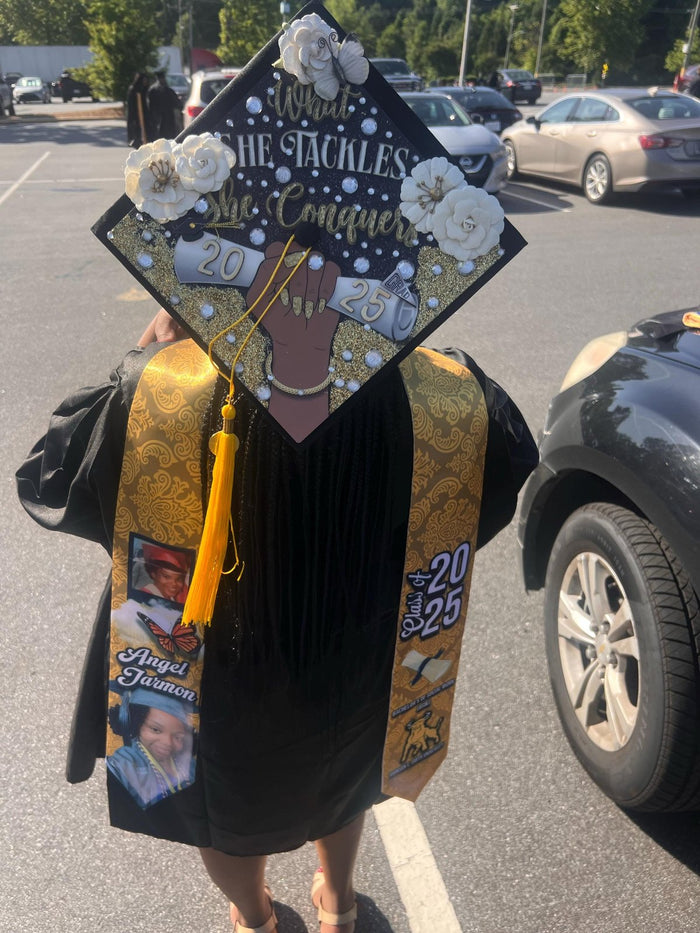 Graduate wearing What She Tackles cap in parking lot