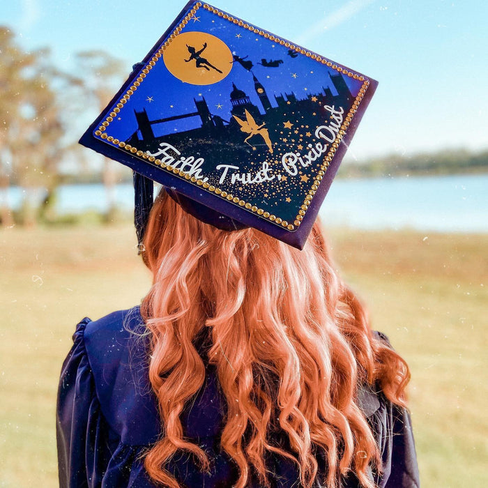 Graduate wearing Peter Pan Faith Trust Pixie Dust cap