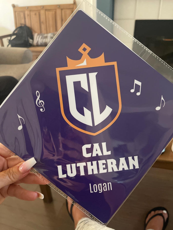 Hand holding Cal Lutheran Logan topper