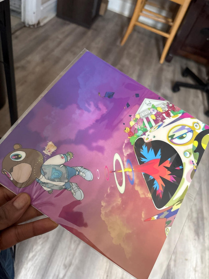 Hand holding Kanye topper