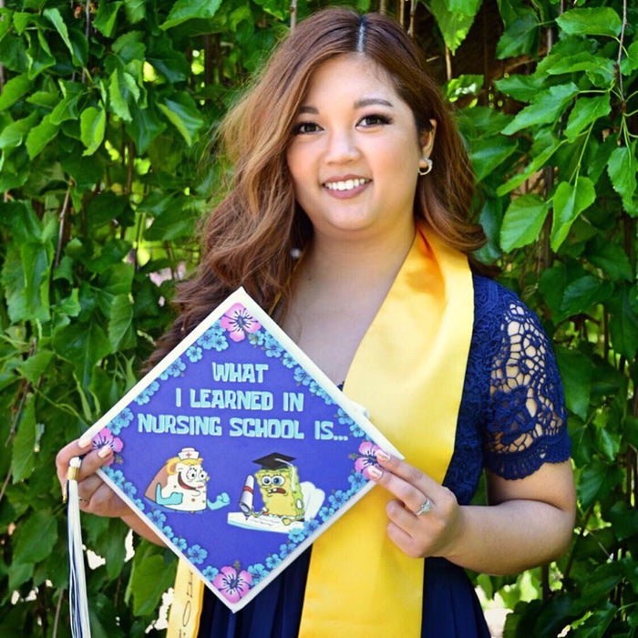 Graduate holding SpongeBob nursing school cap