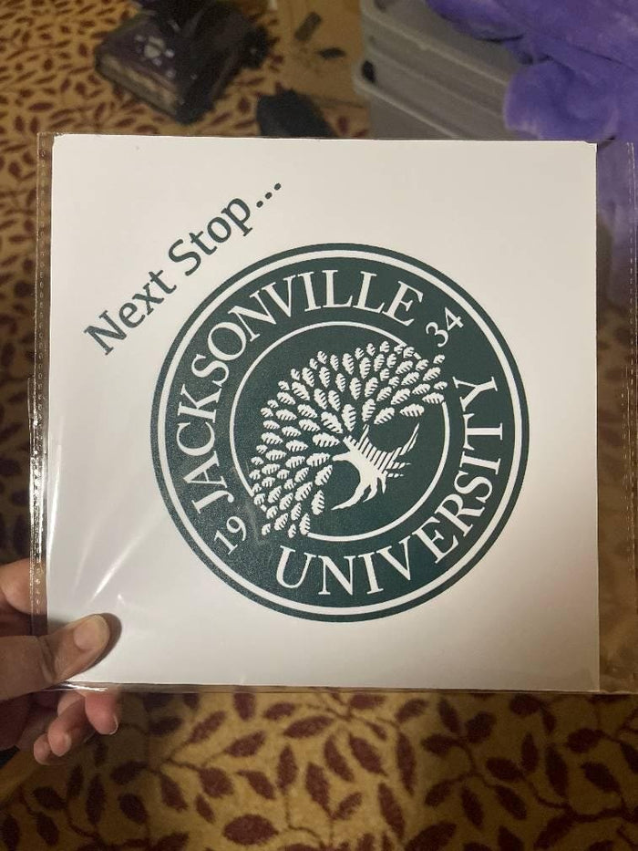 Hand holding Jacksonville University topper