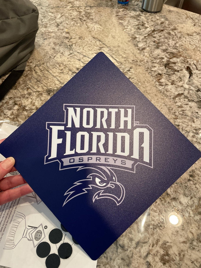 Hand holding North Florida Ospreys topper
