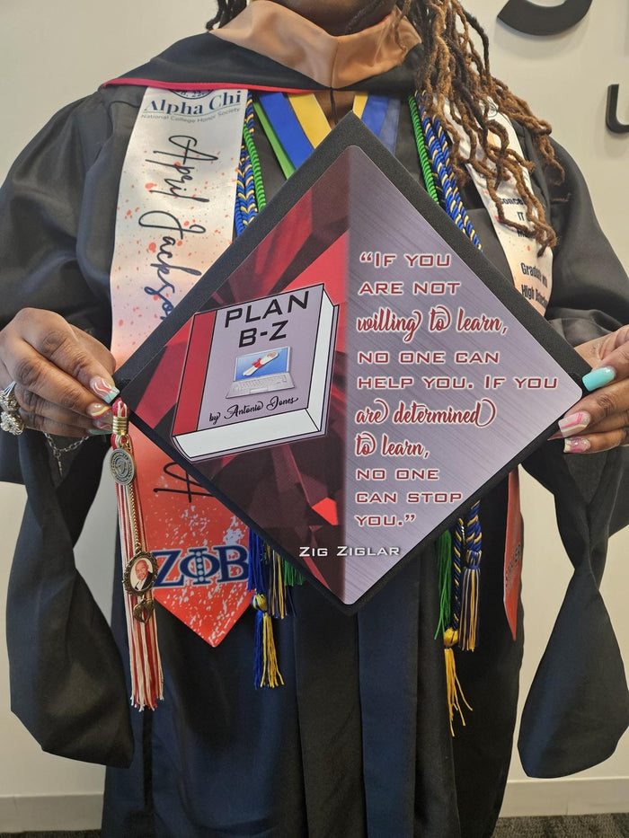 Graduate holding Plan B-Z book topper