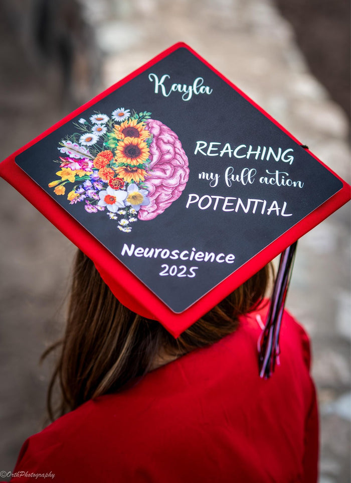 Graduate wearing Kayla floral brain Neuroscience cap