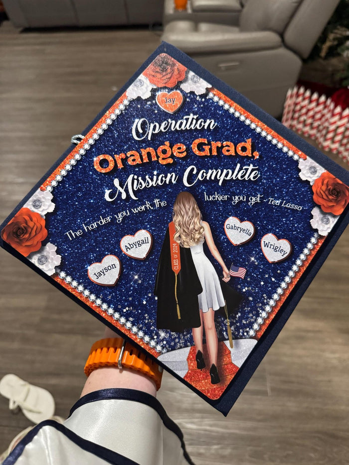 Arm holding Operation Orange Grad topper