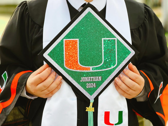 Graduate holding Miami U Jonathan cap