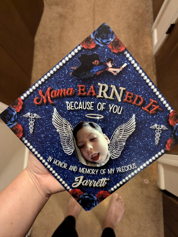 Hand holding Mama Earned It memorial topper